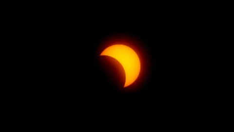 Slow zoom-in on partial phase of solar eclipse. Stock Footage 274039495