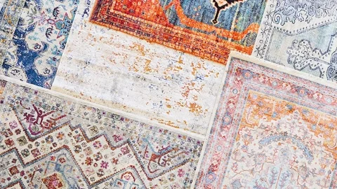Slow Zoom Reveals Array of Colorful Rug Swatches Lined on Floor Stock Footage 313938198