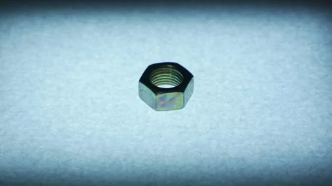 Slow Zoom In on Single Metal Hex Nut on Textured Surface Stock Footage 340069315