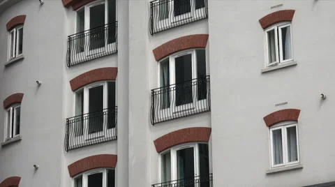 Slow zoom into windows of apartment block in city centre, belfast Stock Footage 42123228
