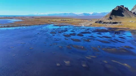 Slowly Advancing Across Reflective Flats Beneath Vestrahorn Stock Footage 342267754