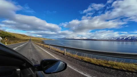 Slowly Advancing Along a Mountain-Lined Waterside Road in Iceland Stock Footage 342270498