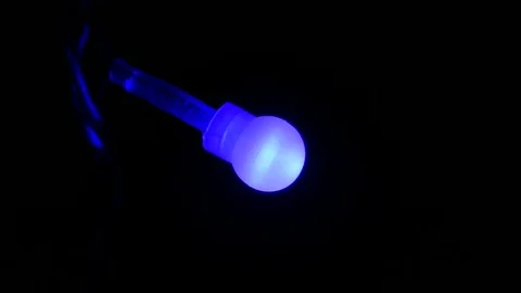 Slowly Blinking  garland  blue light  on dark Background.Close up Video stock 86522960