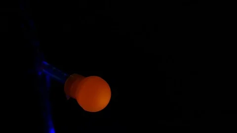 Slowly Blinking  garland  orange  light  on dark Background.Close up Stock Footage 86523072
