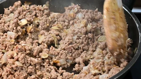 Slowly browning minced beef with onion Stock Footage 219878559