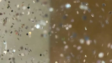 Slowly chaotically moving shiny sparkles on a blurred background Stock Footage 221636336