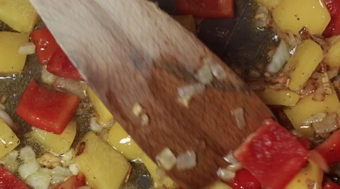 Slowly chopped various vegetables with pepper being fried in a pan Stock Footage 45416541