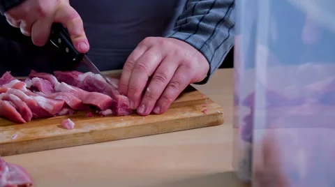 Slowly cutting a big piece of raw meat into smaller tiny pieces Video stock 59737148