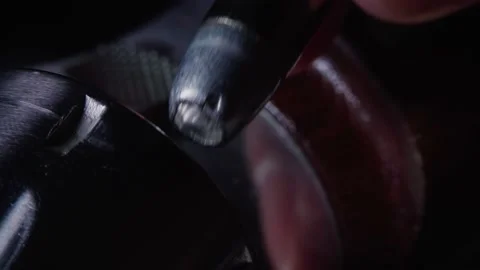 Slowly dropping hollow point bullets in chambers of stainless revolver in dark Stock Footage 161867368