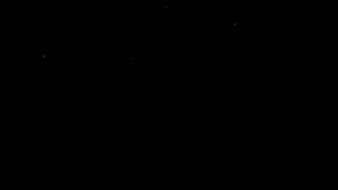Slowly falling round shaped gold sequins on a black background HD Stock Footage 136311467