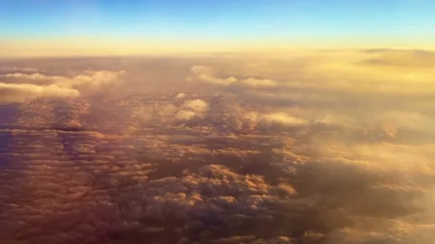 Slowly floating clouds over the earth at sunlights. View from plane. Stock Footage 168950550
