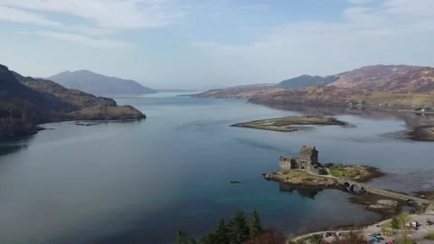Slowly flying away from the beautiful Eilean Donan Castle in the highlands of Stock Footage 255508767