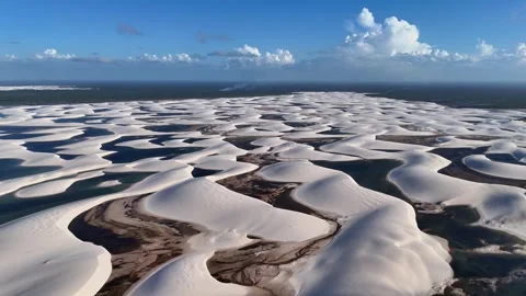 Slowly Gliding Above White Dune Ridges and Dark Lagoons at Lençóis Maranhenses Video stock 342443548