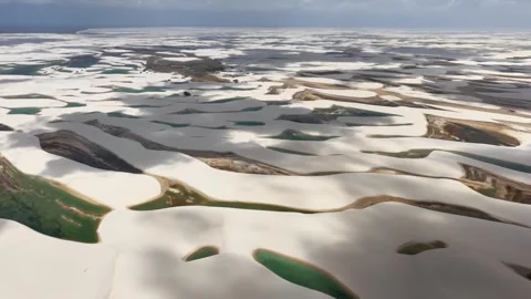 Slowly Gliding Over White Dunes and Emerald Lagoons in Lençóis Maranhenses Video stock 342440929