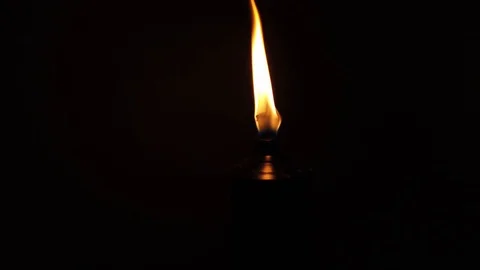 Slowly moving away from a burning torch in the dark, only showing the top of Stock Footage 120040980