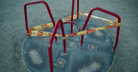 A Slowly Moving Closed Down Merry Go Round Swing in an Empty Kids' Stock Footage 128684749