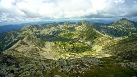 Slowly moving clouds and shadows over sunny mountain peak Stock Footage 93691772