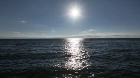 Slowly moving forward into the sunshine above the water surface Stock Footage 337250541