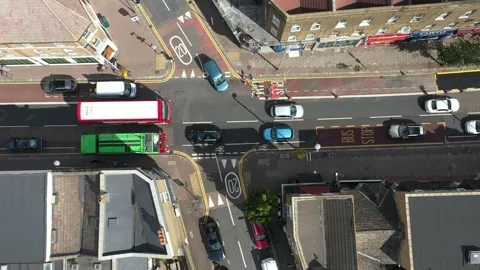 Slowly moving queue of vehicles in street between townhouses Stock Footage 161292471