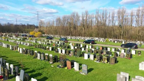 SLOWLY MOVING VEHICLES IN A LONG QUEUE AT THE CEMETERY, DRONE VIEW Stock Footage 150760703