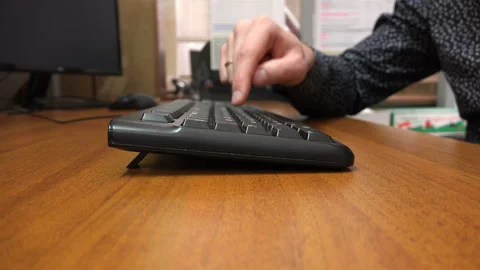 Slowly, with one finger, a man types on the keyboard Stock Footage 111539787