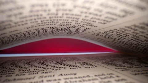 Slowly pulling lens out of book, diagonal view of the pages. Words eye Stock Footage 111314985