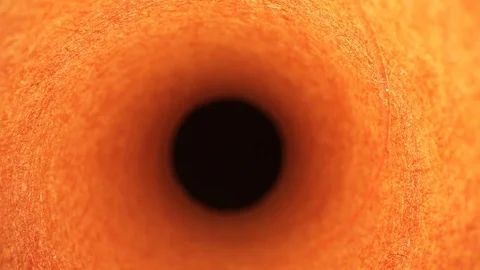 Slowly pulling out of a orange paint roller cover (tube), great texture Stock Footage 116032480
