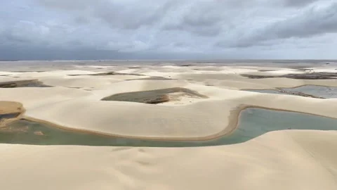 Slowly Rising Over Interlocking Lagoons and Pale Dunes at Lençóis Maranhenses Stock Footage 342441668