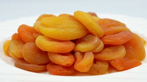 Slowly rotating dried apricots Stock Footage 154047049