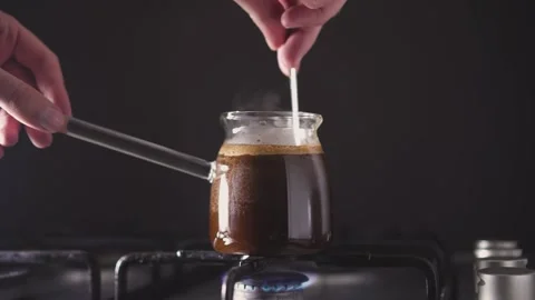 Slowly stirs the brewing coffee Video stock 168751565
