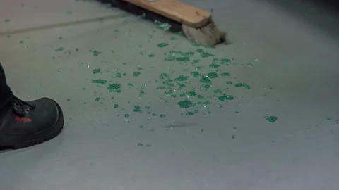 Slowly sweeping the floor because there is glass on the floor Stock Footage 85503277