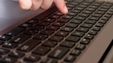 Slowly typing on keyboard Stock Footage 76680555