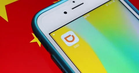 Slowly zoom out DiDi app icon on iPhone on Chinese flag Stock Footage 158933937