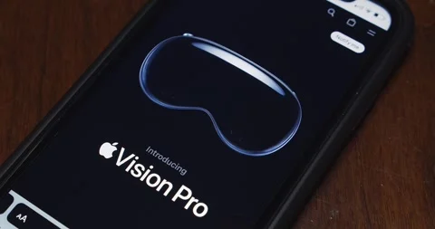 Slowly zoom out an official website of Apple Vision Pro seen in an iPhone Stock Footage 243776091