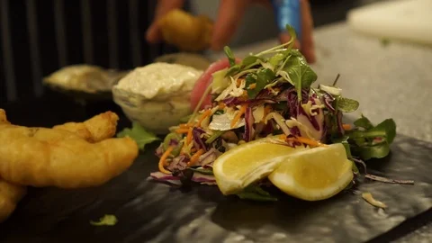 SLOWMO - Chef finishing dish fried shrimps, fish, chicken, green salad, Stock Footage 100319966