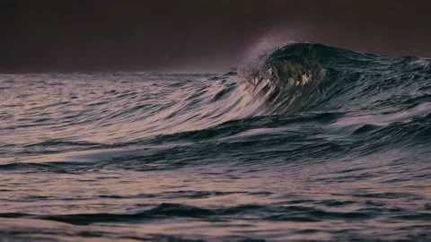 Slowmo closeup of a wave breaking in the sunset Stock Footage 241011520