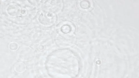 Slowmo falling rain drops, transparent water surface splash, ripple wave texture Video stock 250378361