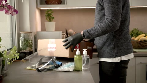 Slowmo: Leaving The Package And All COVID-19 Protection Items In The Kitchen Stock Footage 142862461