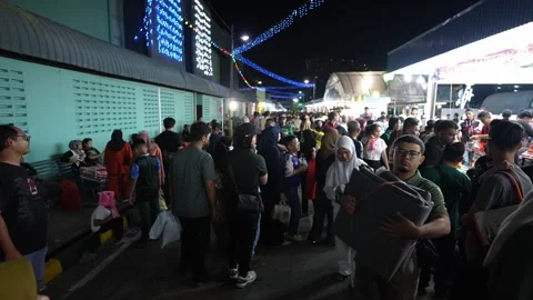 Slowmo night market crowd walking along outdoor stalls and illuminated lights Stock Footage 332730582