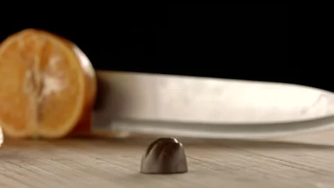 Slowmo Packshot of Praline with Oranges in the Background Stock Footage 148490540