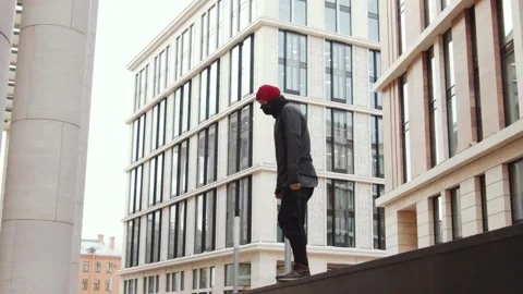 Slowmo of Parkour Athlete Doing Front Flip off Urban Ledge Stock Footage 135867189