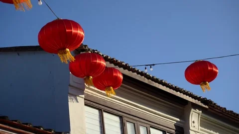 Slowmo red lanterns hanging over shophouse rooftop Stock Footage 333043117