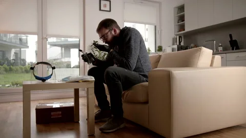 Slowmo: Using A Hand Sanitiser After Unpacking A Pandemic COVID-19 Package Stock Footage 142863155