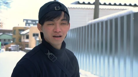 Slowmo - Young Asian Mixed Ethnicity Man Sliding on Ice Stock Footage 101011236