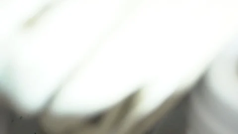 SLOWMOTION Adding a towel to a top loading laundry machine filling up with hot Stock Footage 93241983