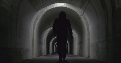 SlowMotion - Back view of a person walking in a tunnel Stock Footage 172467847