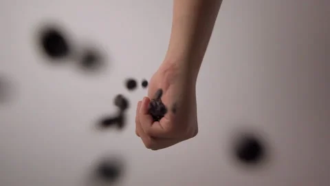 Slowmotion bottom view releasing coffee beans from the barista's hand. Stock Footage 196676704