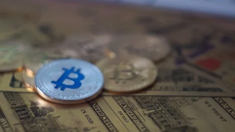 Slowmotion. Camera moving around bitcoin coins and golden money dollars and euro Stock Footage 104192824