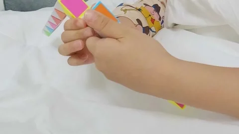 Slowmotion, a child's hand playing with a cube toy Video stock 301783778