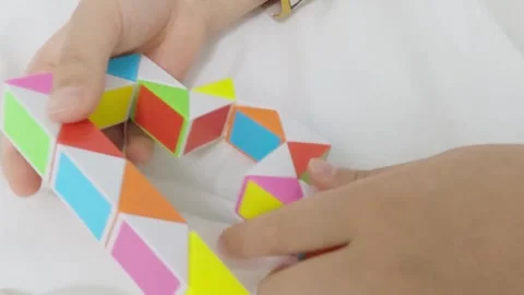 Slowmotion, a child's hand playing with a cube toy Video stock 301783779